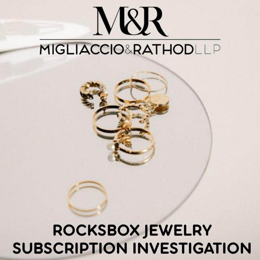 Gold rings on a plate with the Migliaccio & Rathod LLP logo
