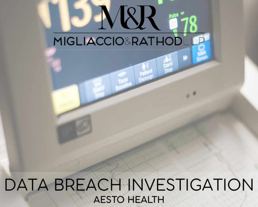 Graphic announcing the Aesto Health data breach investigation featuring the Migliaccio & Rathod LLP logo and a background image of a hospital monitor device printing out health data information.